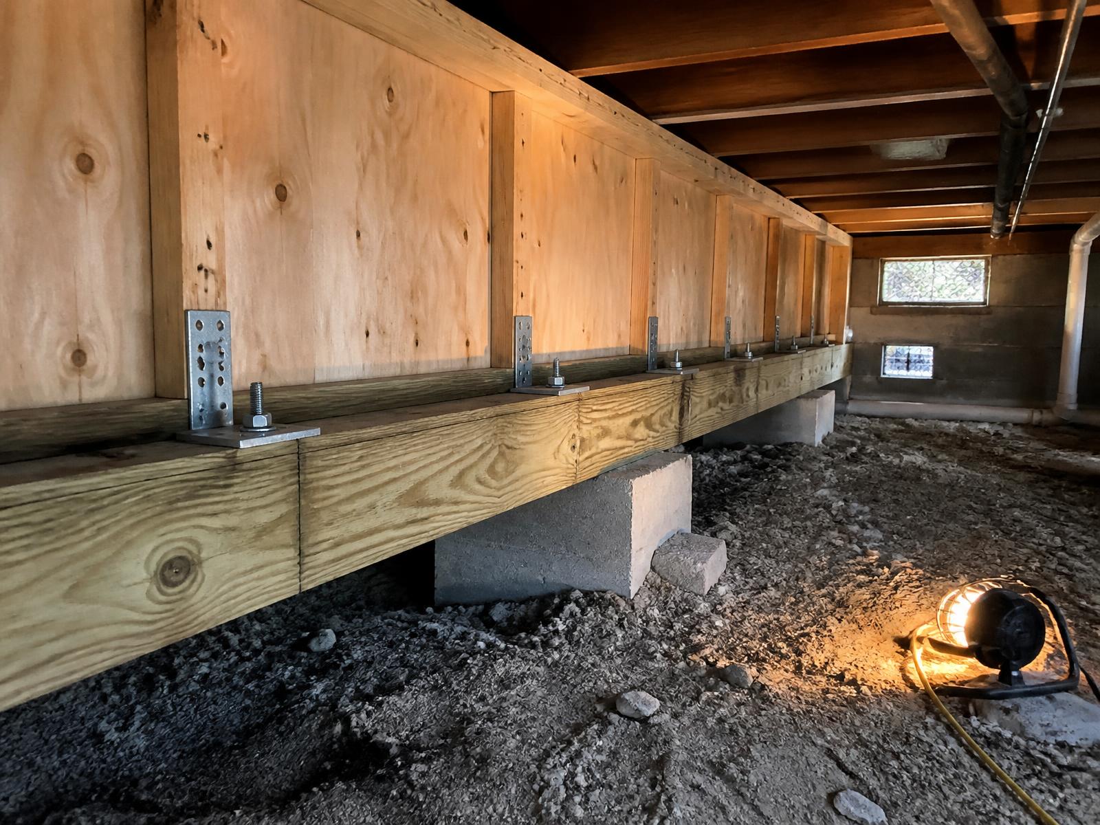 Crawl space foundation retrofit with new anchor bolts, steel plates and plywood cripple wall bracing