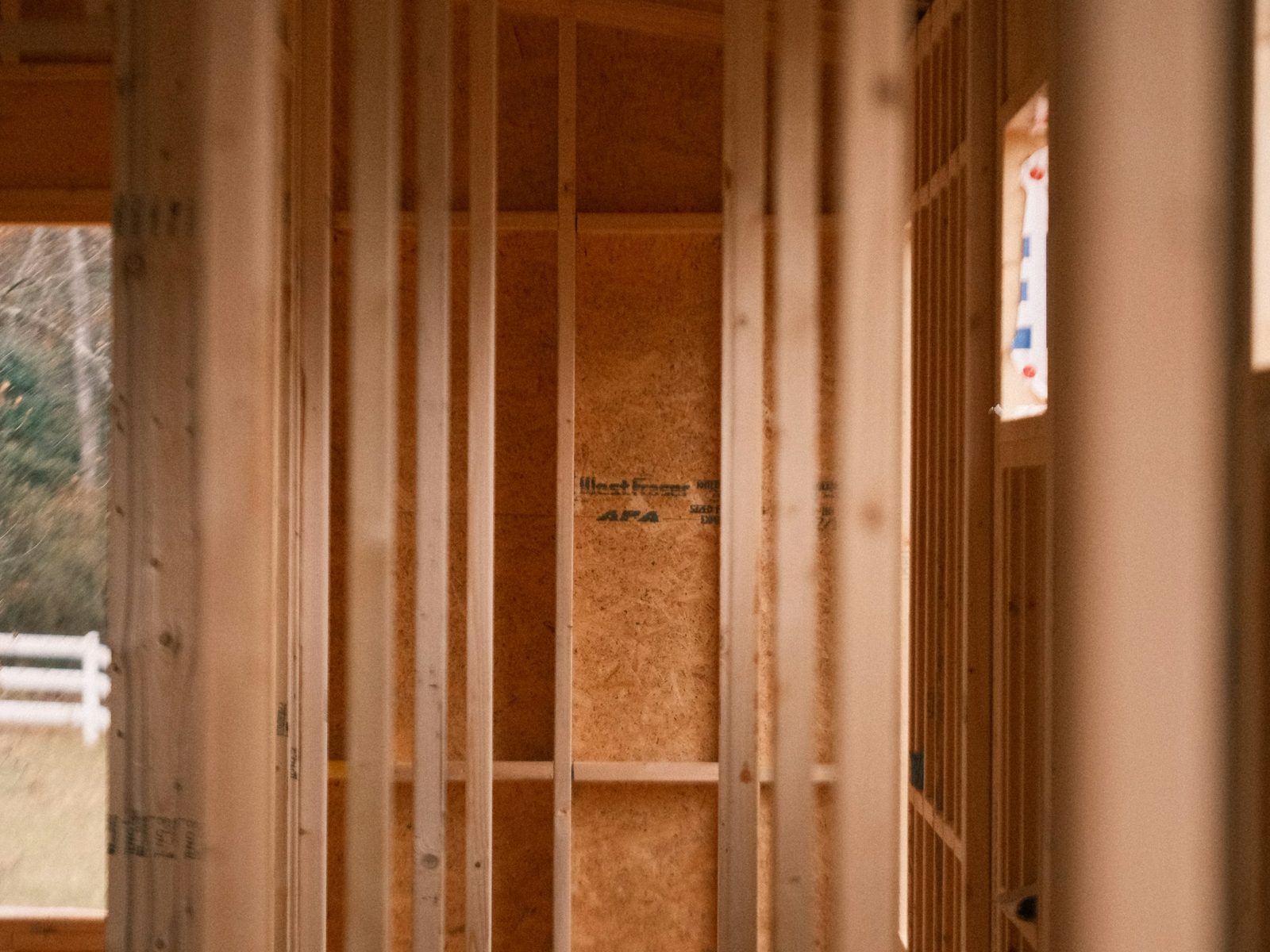 Wood stud framing and sheathing for new residential living space under construction